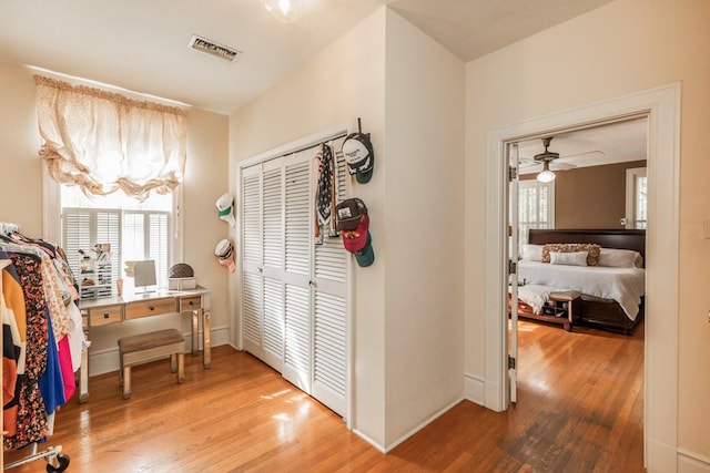 hall with hardwood / wood-style floors