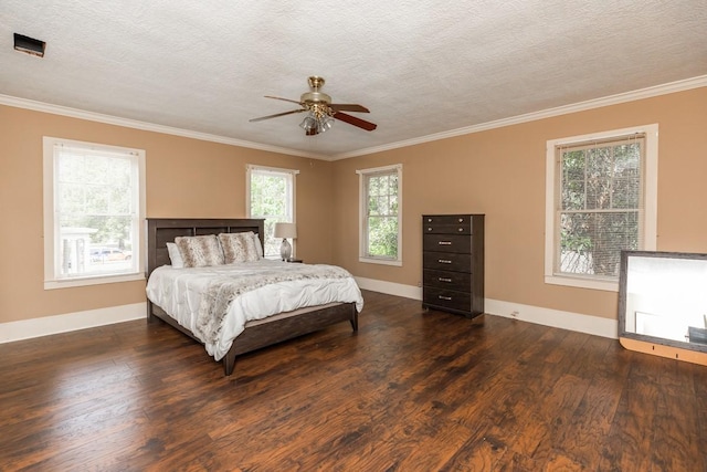 bedroom with multiple windows, a textured ceiling, and dark hardwood / wood-style flooring