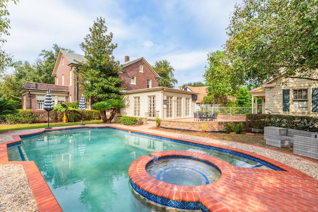 view of pool featuring an in ground hot tub and an outdoor structure