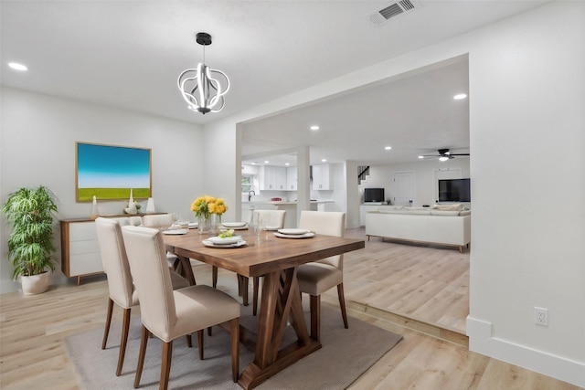 dining area featuring a chandelier and light hardwood / wood-style floors