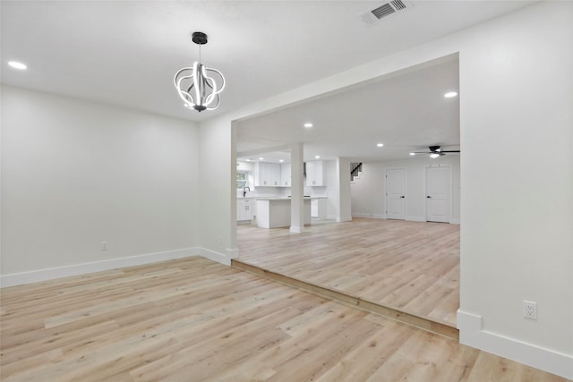 interior space featuring sink, a chandelier, and light hardwood / wood-style floors