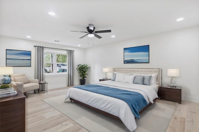 bedroom with ceiling fan and light hardwood / wood-style floors