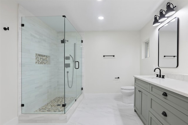 bathroom featuring vanity, a shower with shower door, and toilet