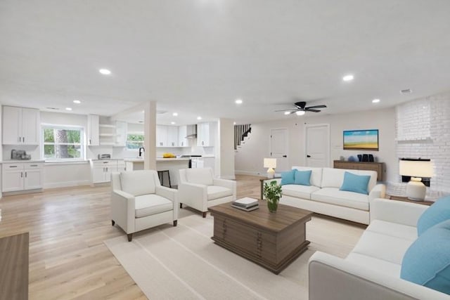 living room featuring ceiling fan and light hardwood / wood-style floors