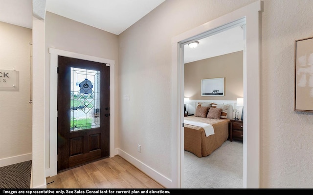 14123 Gingko Ct, Crosby, TX 77532 - entryway featuring light wood-style flooring, baseboards, and a textured wall