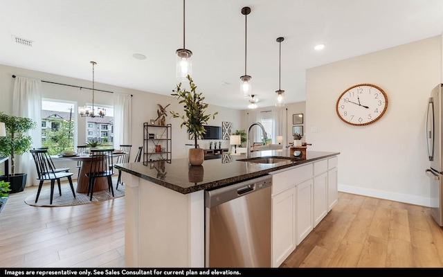 14123 Gingko Ct, Crosby, TX 77532 - kitchen featuring stainless steel appliances, a sink, light wood finished floors, plenty of natural light, and recessed lighting