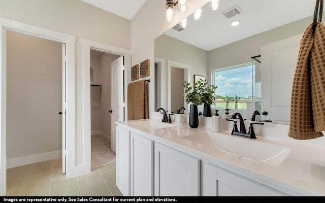 14123 Gingko Ct, Crosby, TX 77532 - bathroom with tile patterned flooring, double vanity, a spacious closet, and baseboards