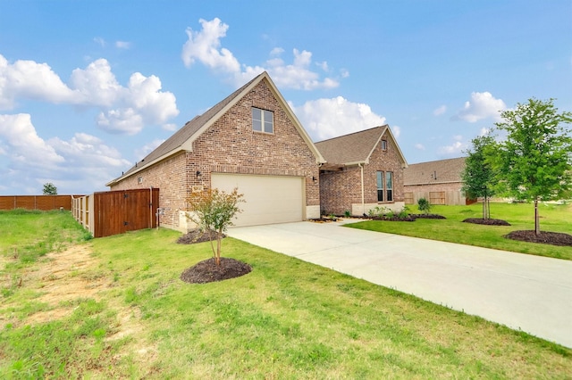 traditional-style home with brick siding, fence, concrete driveway, a front yard, and a garage