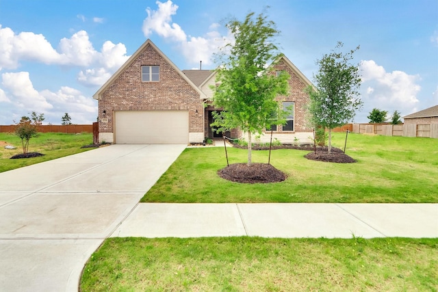 traditional-style house featuring a front lawn, concrete driveway, fence, and brick siding