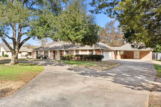 view of front of home with a garage and a front lawn