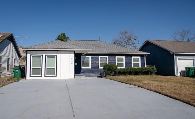 ranch-style home featuring a garage and a front yard