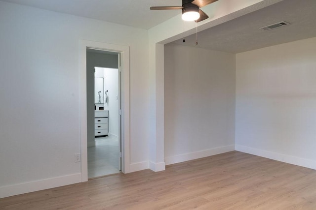 empty room featuring ceiling fan and light hardwood / wood-style flooring