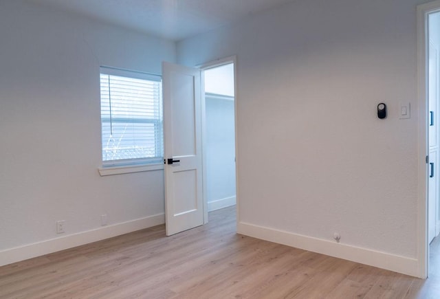 spare room with light hardwood / wood-style flooring