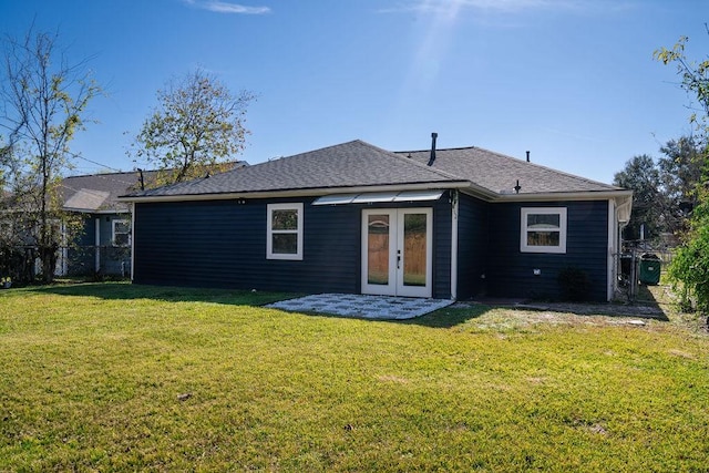 back of property with french doors and a lawn