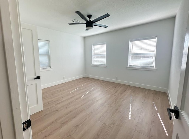 unfurnished room with ceiling fan and light hardwood / wood-style floors