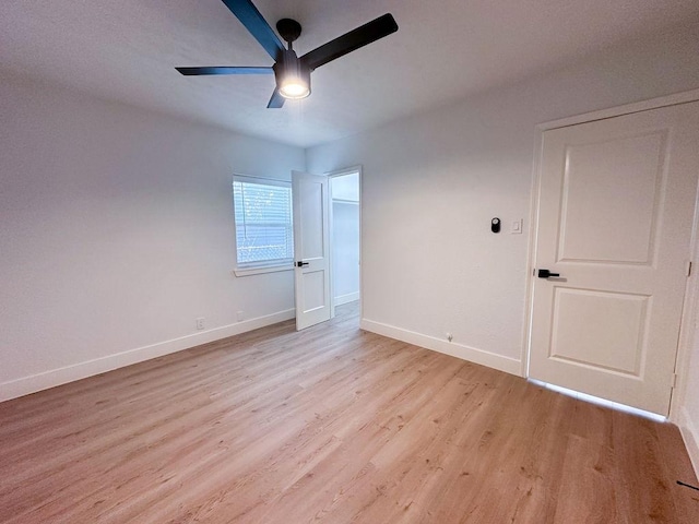 unfurnished room featuring ceiling fan and light wood-type flooring