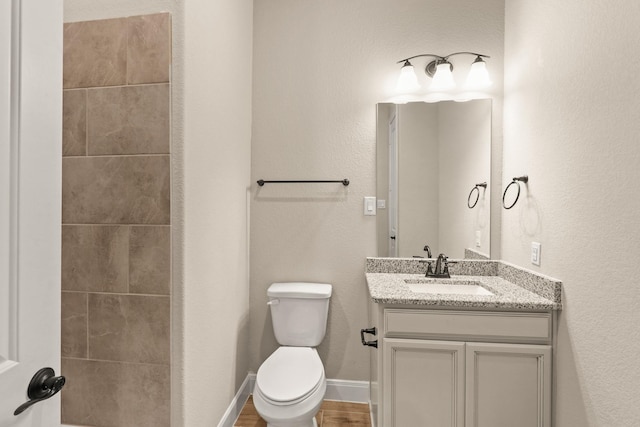 bathroom featuring hardwood / wood-style flooring, vanity, and toilet