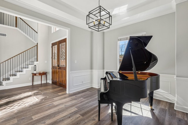 miscellaneous room with an inviting chandelier, hardwood / wood-style floors, and ornamental molding