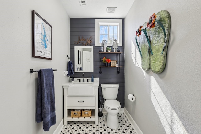 bathroom with vanity, toilet, and tile patterned flooring