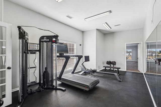 exercise room with a textured ceiling