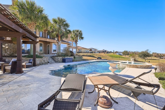 view of swimming pool featuring an in ground hot tub and a patio area