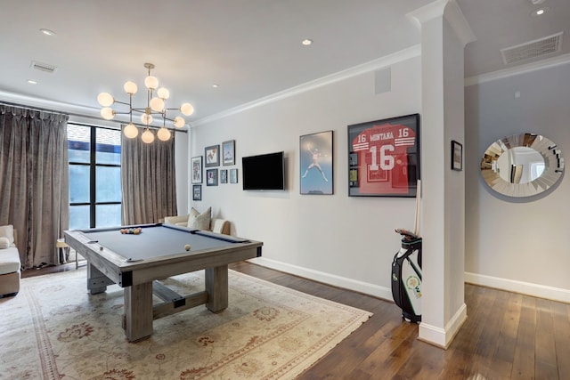 recreation room with baseboards, visible vents, dark wood-style flooring, and ornamental molding