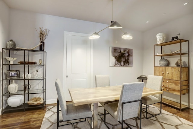 dining area featuring wood finished floors and baseboards