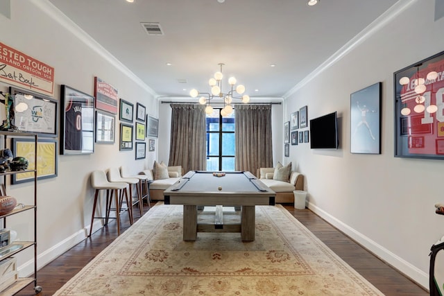 recreation room featuring ornamental molding, dark wood finished floors, visible vents, and baseboards