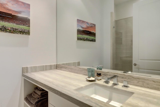 full bath with tiled shower and vanity