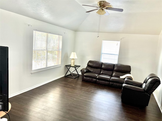 living room featuring vaulted ceiling, dark hardwood / wood-style floors, and ceiling fan