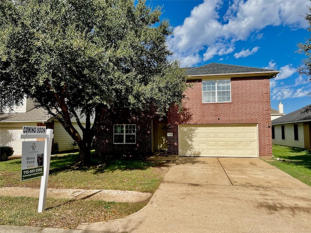 view of front of house featuring a garage and a front lawn