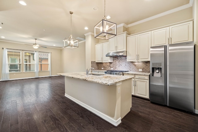 kitchen featuring hanging light fixtures, stove, stainless steel fridge with ice dispenser, light stone countertops, and a center island with sink