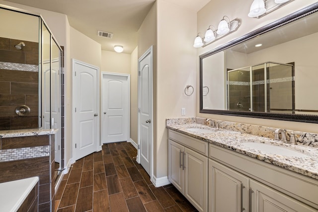 bathroom with vanity and an enclosed shower