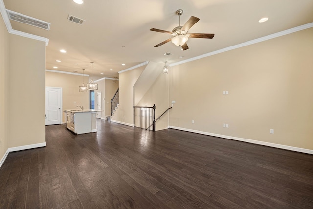 unfurnished living room with crown molding, sink, ceiling fan, and dark hardwood / wood-style flooring