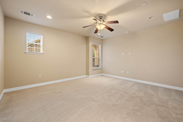 carpeted empty room featuring ceiling fan