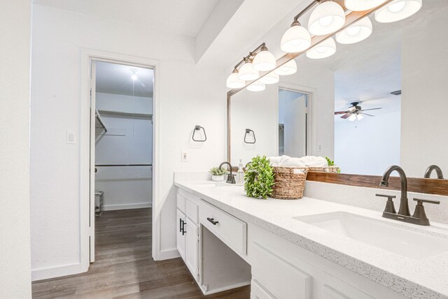 bathroom with hardwood / wood-style flooring, vanity, and ceiling fan