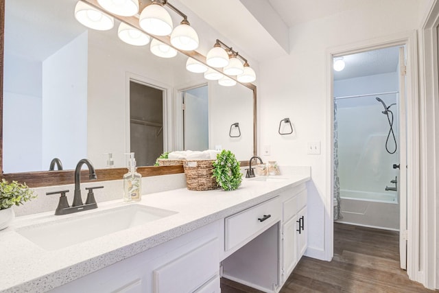 bathroom with vanity, hardwood / wood-style floors, and shower / bath combo with shower curtain