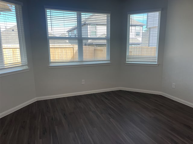 spare room with dark hardwood / wood-style flooring