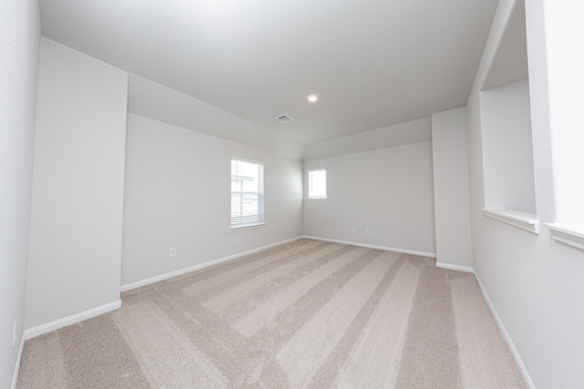 spare room with recessed lighting, visible vents, baseboards, and light carpet