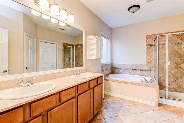 bathroom featuring tile patterned flooring, plus walk in shower, and vanity