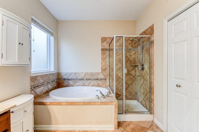 bathroom with plus walk in shower, vanity, and tile patterned floors