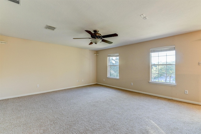 carpeted spare room featuring ceiling fan and a textured ceiling