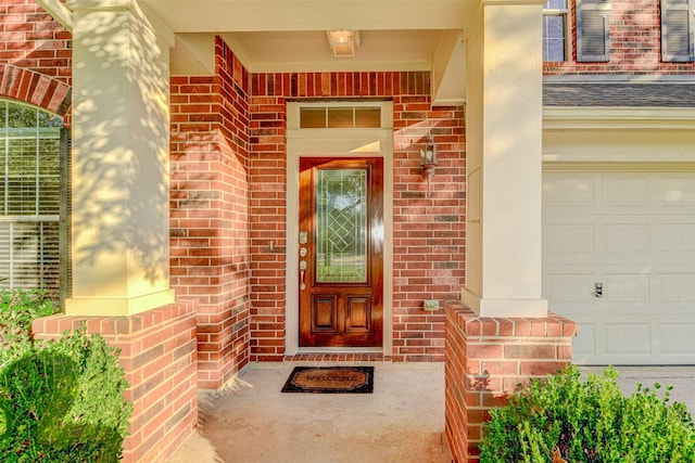 view of exterior entry with a garage