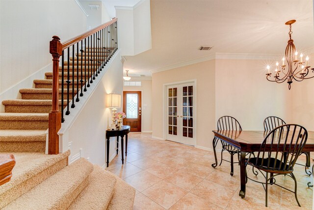 tiled dining area featuring an inviting chandelier, crown molding, and french doors