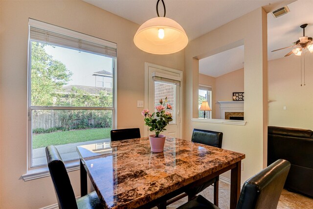 dining space featuring ceiling fan, lofted ceiling, and a wealth of natural light