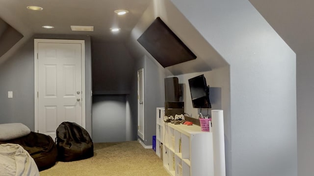 bedroom featuring lofted ceiling and light colored carpet