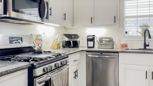 kitchen featuring sink, stainless steel appliances, and white cabinets