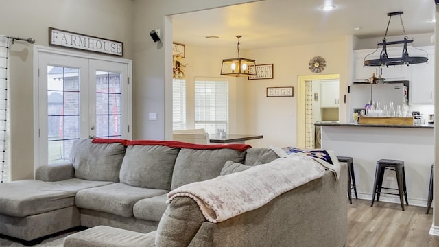 living room with light hardwood / wood-style flooring and french doors