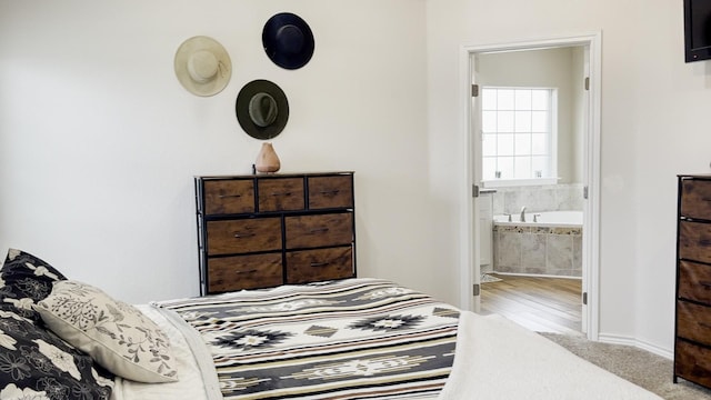 carpeted bedroom featuring connected bathroom