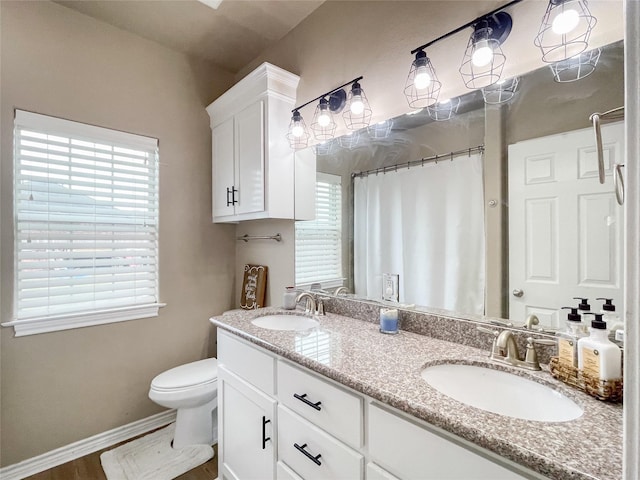 bathroom featuring a shower with curtain, vanity, and toilet